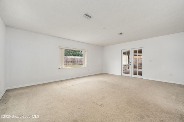 spare room with french doors and carpet flooring