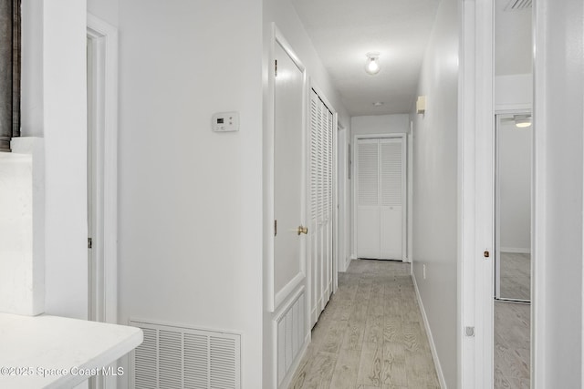 corridor featuring light hardwood / wood-style floors