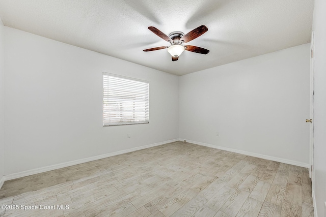 unfurnished room with ceiling fan, light hardwood / wood-style flooring, and a textured ceiling