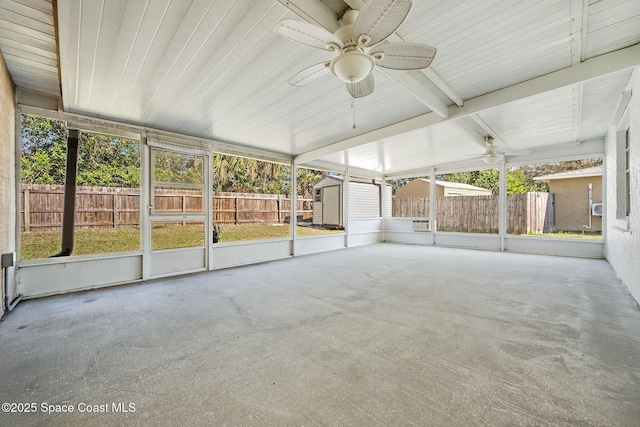 unfurnished sunroom with ceiling fan