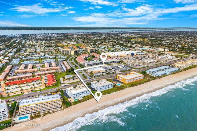 drone / aerial view with a water view and a view of the beach