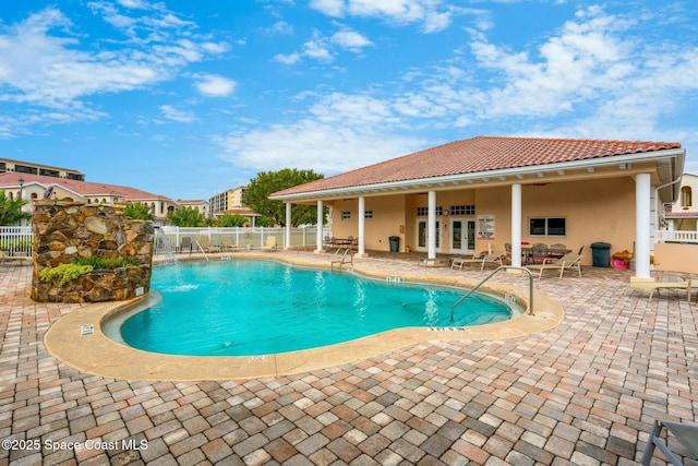 view of pool with french doors and a patio area