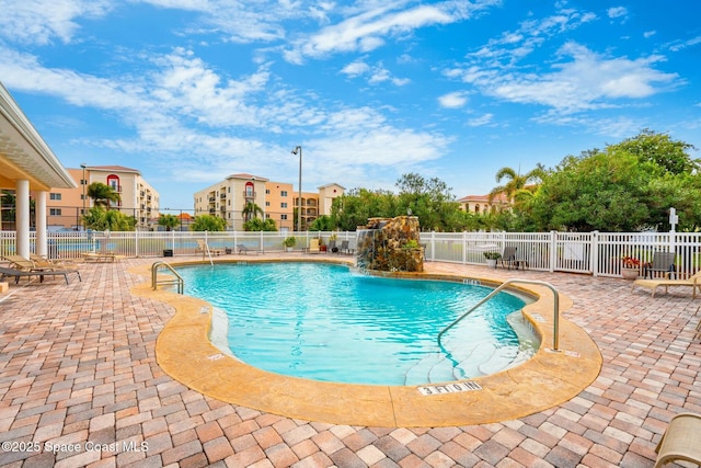 view of swimming pool with a patio area and pool water feature