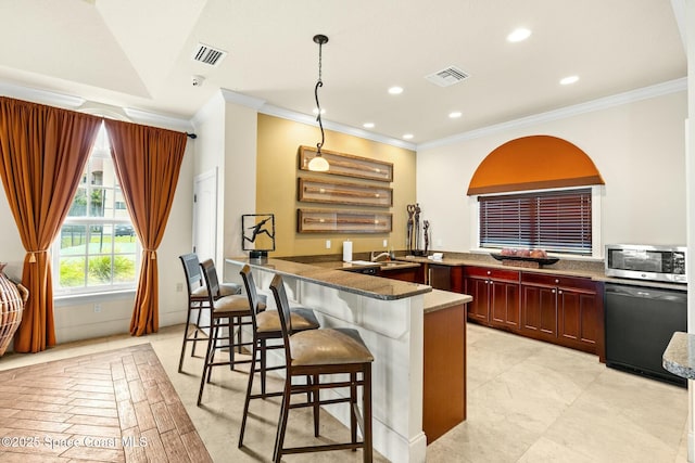 kitchen featuring dishwasher, decorative light fixtures, dark stone counters, ornamental molding, and a breakfast bar