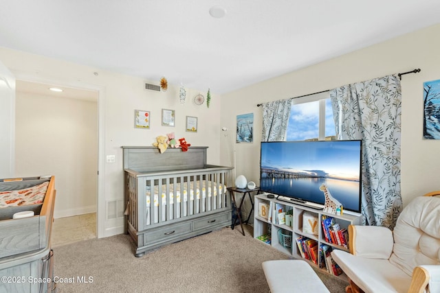 carpeted bedroom featuring a crib