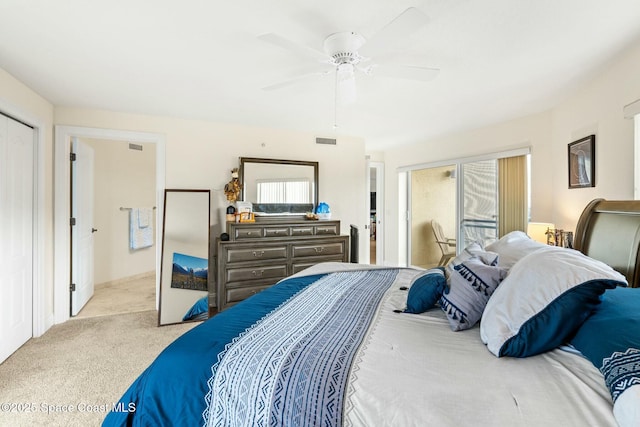 bedroom featuring ceiling fan, light colored carpet, and a closet