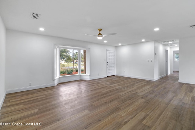 spare room featuring ceiling fan and dark wood-type flooring