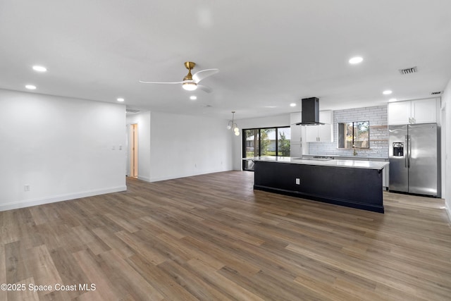 kitchen with extractor fan, a kitchen island, white cabinetry, light wood-type flooring, and stainless steel fridge with ice dispenser