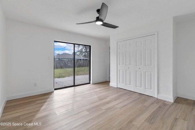 unfurnished bedroom with ceiling fan, a closet, light hardwood / wood-style flooring, and access to outside