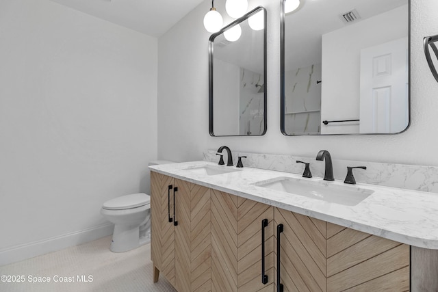 bathroom with toilet and vanity