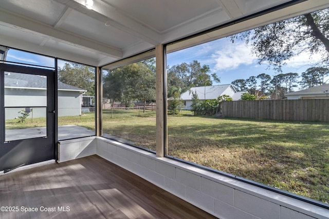 unfurnished sunroom with beamed ceiling