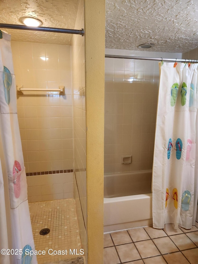 bathroom featuring shower / bath combo with shower curtain, a textured ceiling, and tile patterned floors