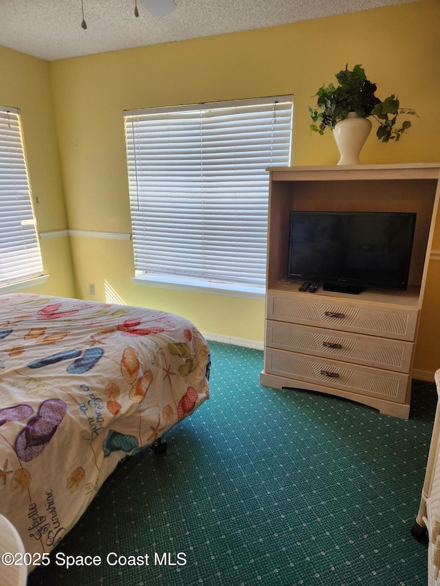 carpeted bedroom featuring a textured ceiling