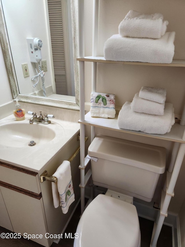 bathroom with toilet and vanity