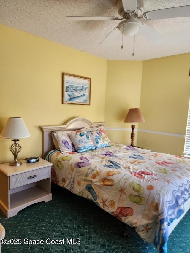 bedroom with carpet, a textured ceiling, and ceiling fan