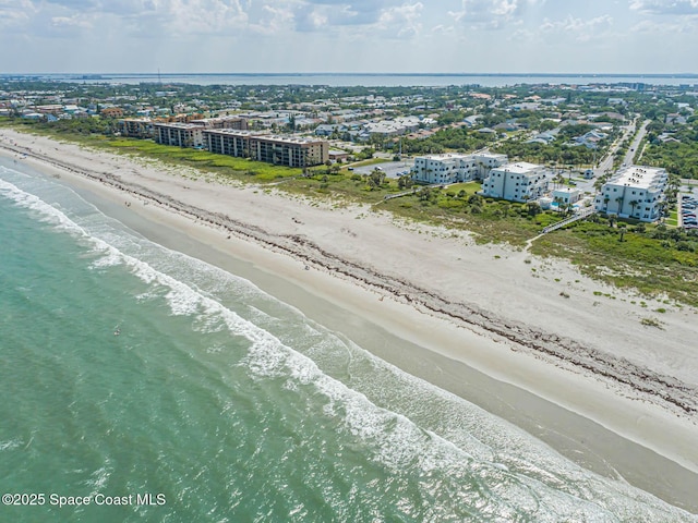 bird's eye view with a water view and a beach view