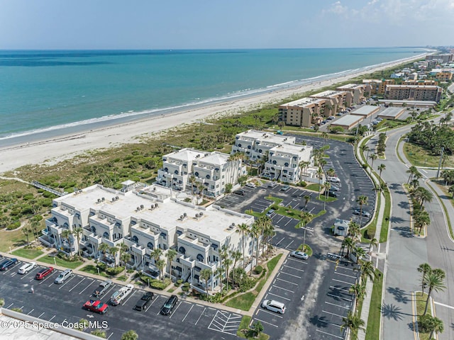 bird's eye view with a water view and a view of the beach