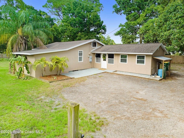 view of front facade with a patio and a front yard