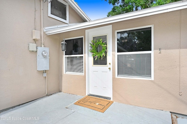 entrance to property with a patio