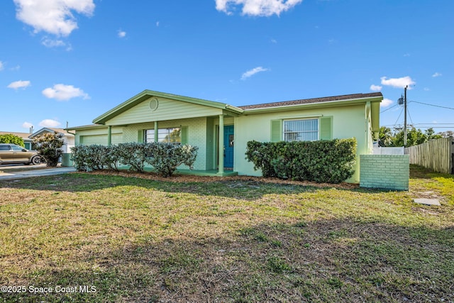 ranch-style home with a garage and a front lawn