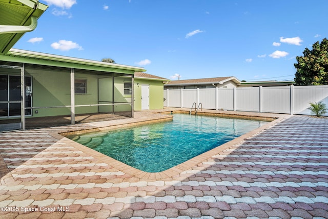 view of swimming pool with a sunroom and a patio