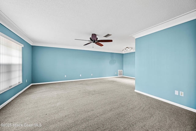 empty room with carpet, ceiling fan, track lighting, ornamental molding, and a textured ceiling