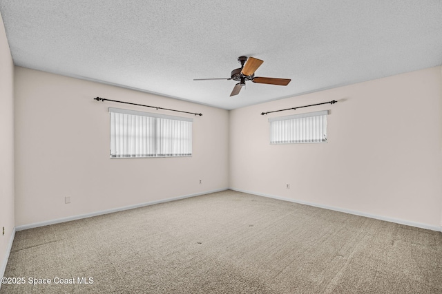 unfurnished room featuring ceiling fan, plenty of natural light, a textured ceiling, and carpet flooring