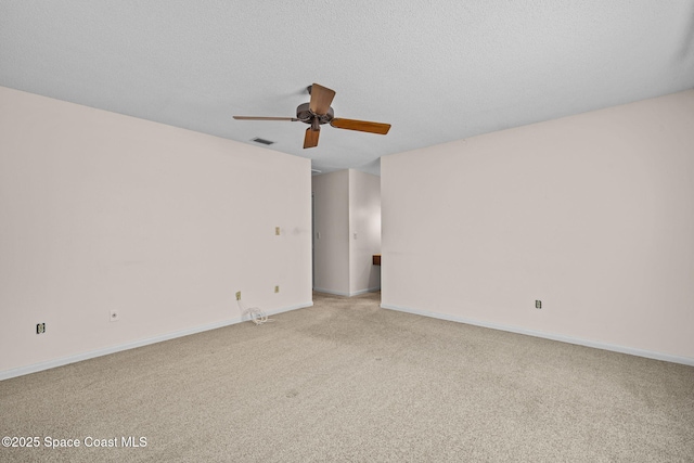 carpeted empty room with ceiling fan and a textured ceiling