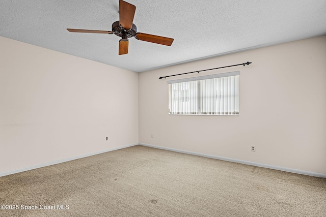 carpeted spare room with a textured ceiling and ceiling fan