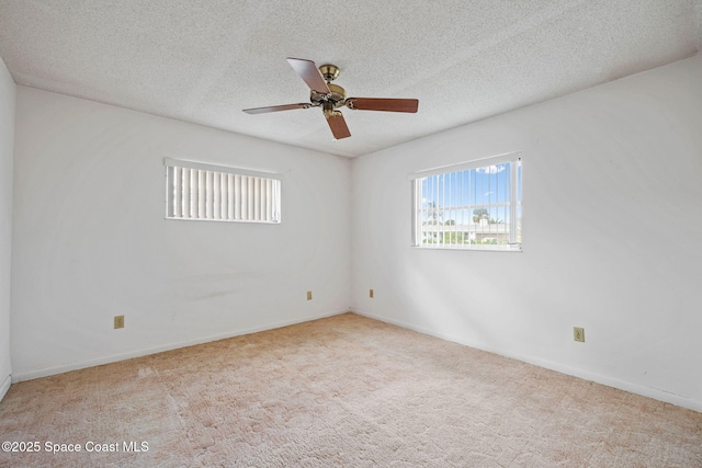 unfurnished room with light carpet, ceiling fan, and a textured ceiling