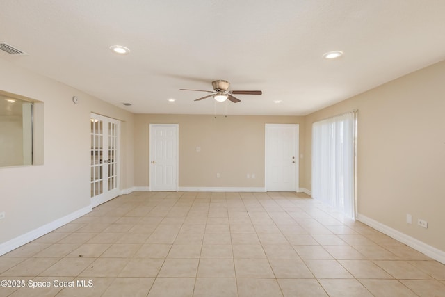 unfurnished room with ceiling fan and light tile patterned floors