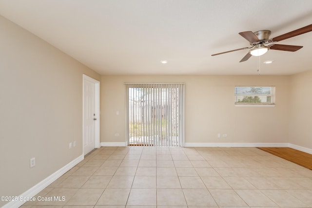 unfurnished room featuring ceiling fan and light tile patterned floors