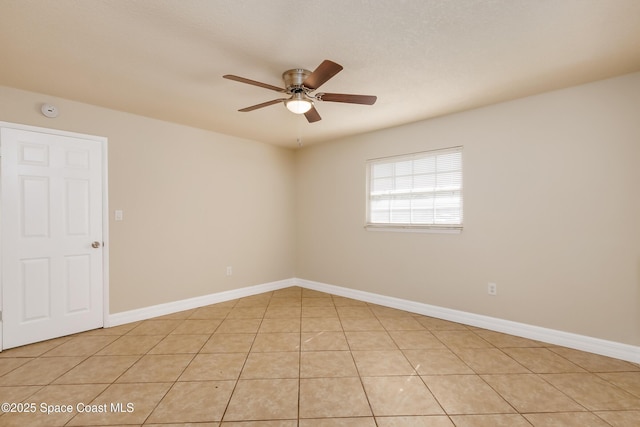 unfurnished room with ceiling fan and light tile patterned flooring