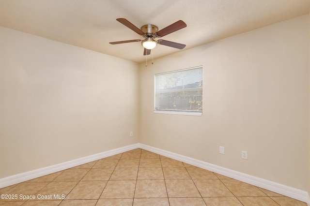 empty room featuring ceiling fan and light tile patterned flooring