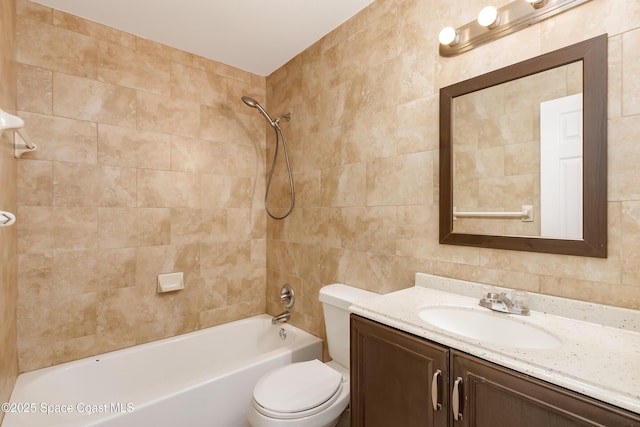 full bathroom featuring toilet, tiled shower / bath, and vanity