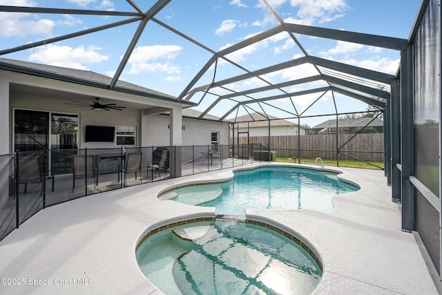 view of swimming pool featuring a patio area, glass enclosure, an outdoor bar, an in ground hot tub, and ceiling fan