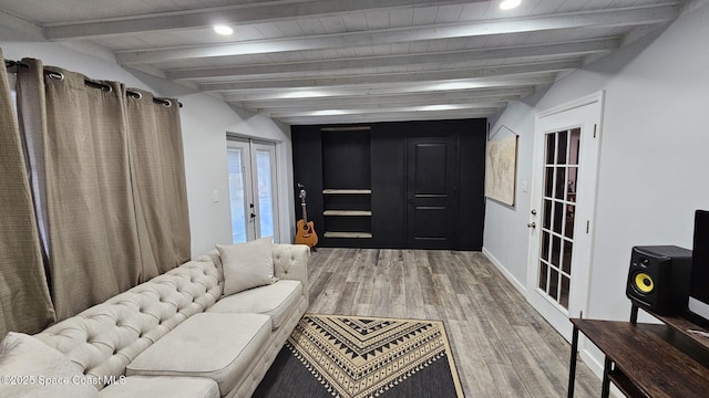 living room featuring french doors, hardwood / wood-style flooring, and beamed ceiling