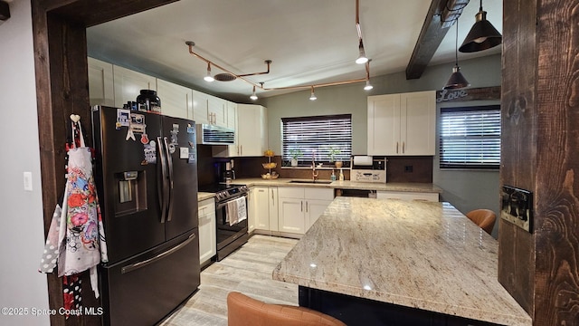 kitchen with decorative light fixtures, sink, appliances with stainless steel finishes, white cabinets, and light stone counters