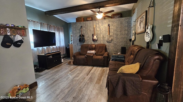 home theater with ceiling fan, vaulted ceiling with beams, and wood-type flooring