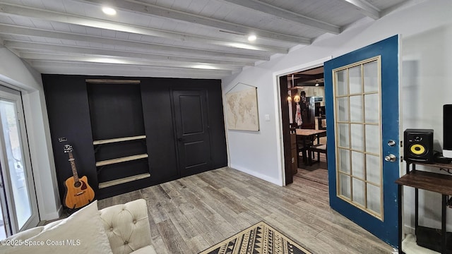 interior space featuring hardwood / wood-style flooring, wooden ceiling, and beamed ceiling