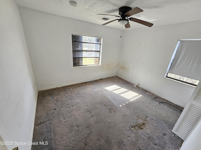 empty room featuring visible vents and a ceiling fan