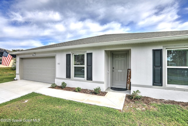 single story home with a front yard and a garage