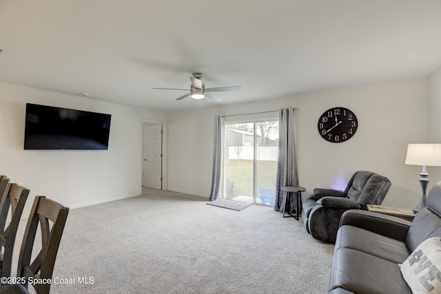 carpeted living room with ceiling fan