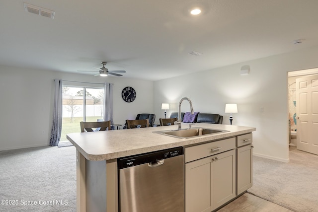 kitchen with light carpet, sink, a kitchen island with sink, ceiling fan, and stainless steel dishwasher