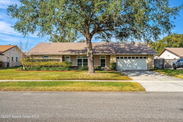 ranch-style house featuring a garage and a front yard