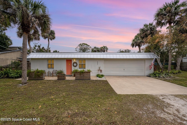 single story home with a yard and a garage