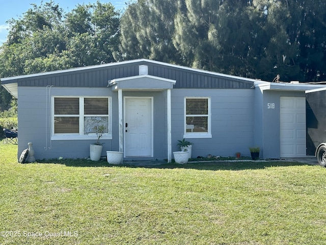 view of front of home with a front lawn and a garage