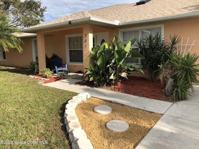 property entrance with a yard