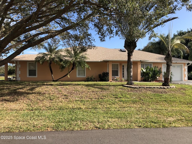 ranch-style house with a garage and a front lawn