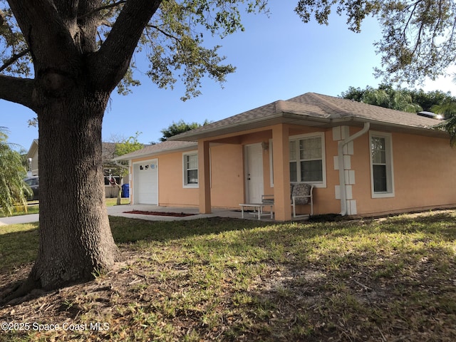 view of front of home with a garage and a front yard